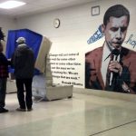 Giant Obama Mural on Polling Wall while voters vote.