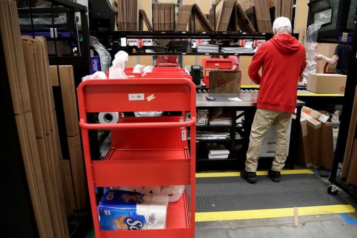 An assembly line worker packages items An assembly line worker packages items