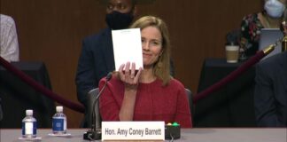 Amy Coney Barrett shows blank notepad.