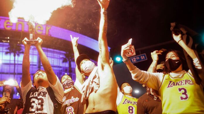 Los Angeles Lakers fans celebrate outside of Staples Center, Sunday, Oct. 11, 2020, in Los Angeles Los Angeles Lakers fans celebrate outside of Staples Center, Sunday, Oct. 11, 2020, in Los Angeles