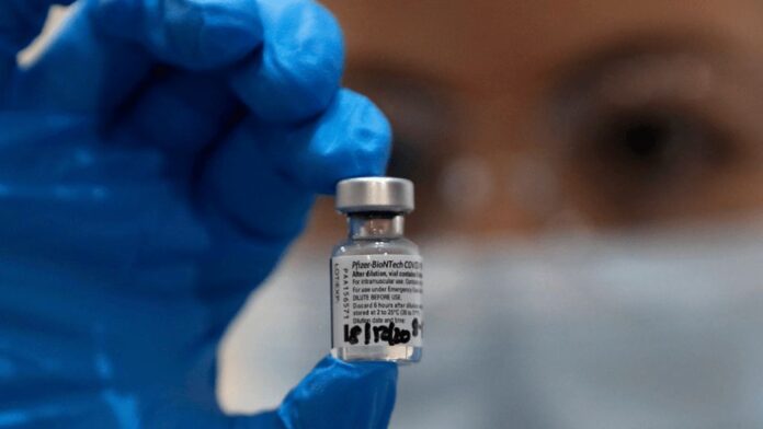 A nurse holds a phial of the Pfizer-BioNTech COVID-19 vaccine