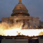 An explosion caused by a police munition is seen while supporters of then-President Donald Trump gather in front of the U.S. Capitol in Washington, D.C., on Jan. 6.