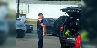 Alabama Police Office Comforting Child