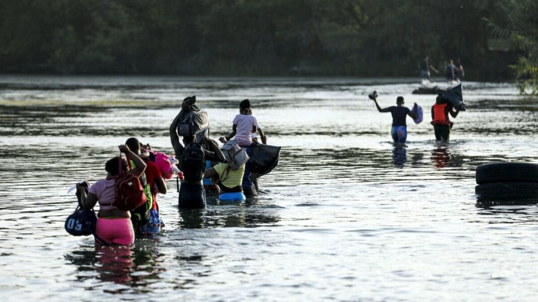 A group of illegal immigrants crosses the Rio Grande from Acuna, Mexico, to Del Rio, Texas