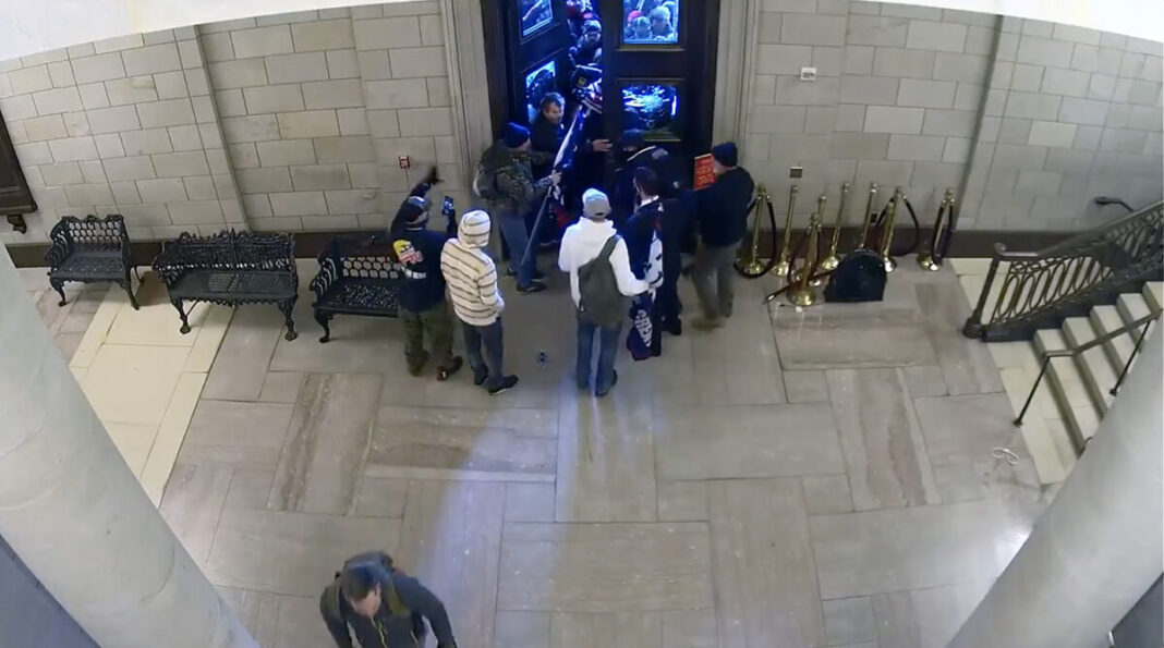 Protesters begin streaming into the U.S. Capitol through the historic Columbus Doors on Jan. 6, 2021.