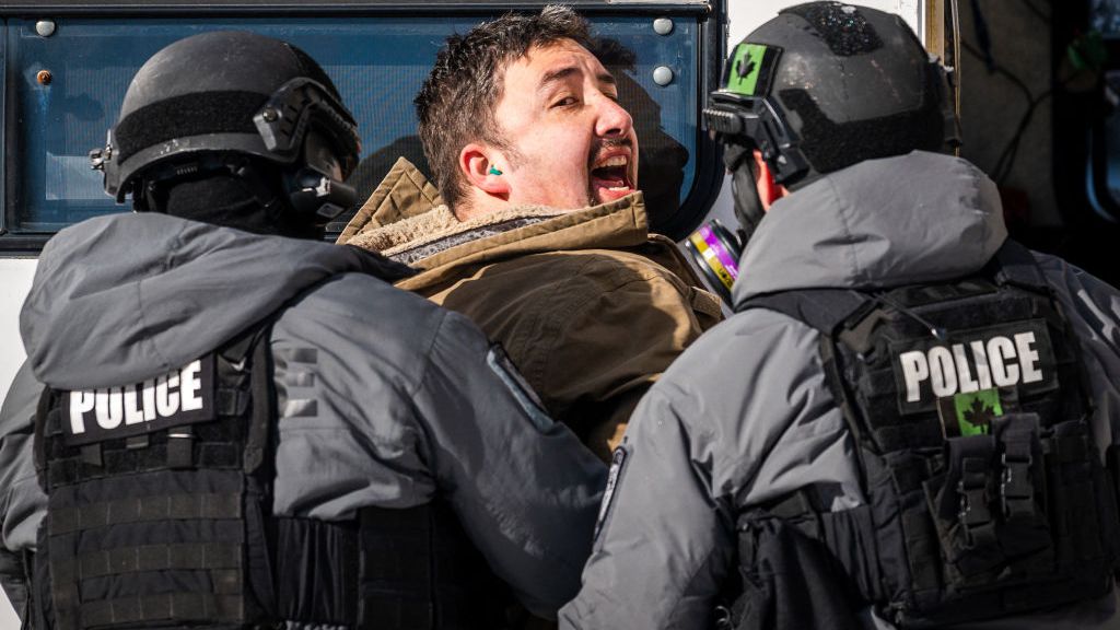 Police arrest a demonstrator protesting against COVID-19 mandates in Ottawa