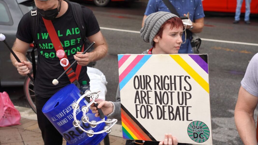 Transgender rights group members protest against the “Our Bodies, Our Sports” rally