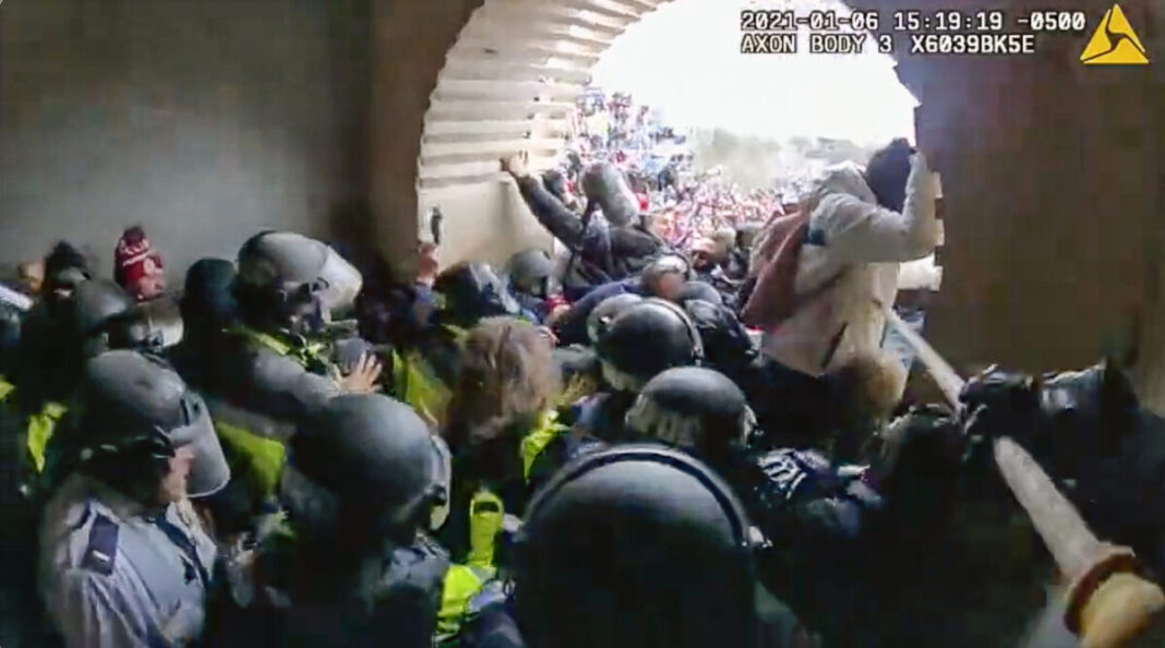 Metropolitan Police Department Officer Michael Dowling uses a flagpole to jab at a protester