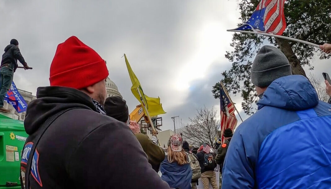 Two members of the Metropolitan Police Department's Electronic Surveillance Unit approach the northwest side of the Capitol on Jan. 6, 2021.