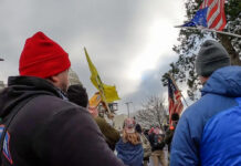 Two members of the Metropolitan Police Department's Electronic Surveillance Unit approach the northwest side of the Capitol on Jan. 6, 2021.