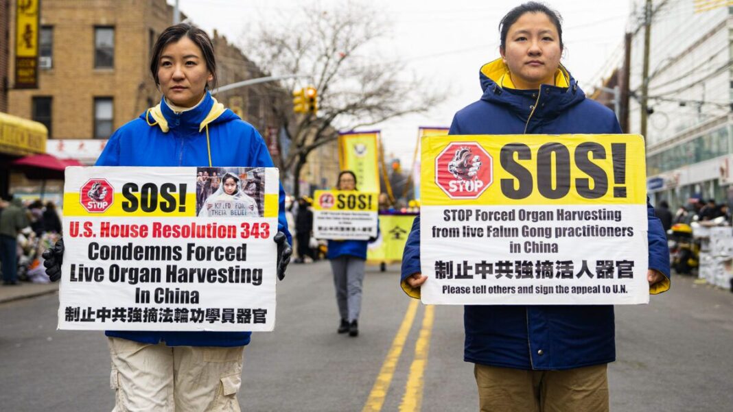 Falun Gong practitioners walk in a parade in Brooklyn, N.Y.