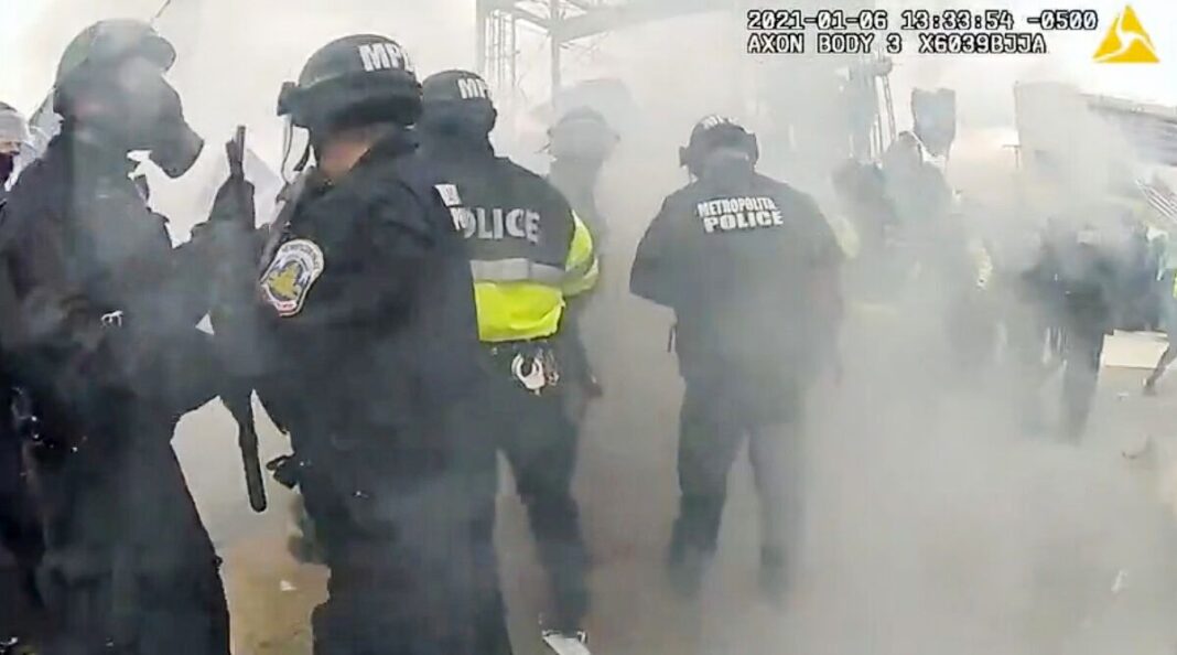 Police officers scatter after an MPD officer misfired a tear gas