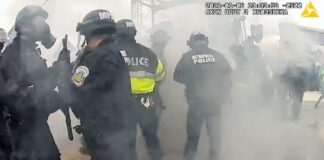 Police officers scatter after an MPD officer misfired a tear gas