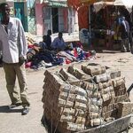 Wheel barrow of money in Zimbabwe