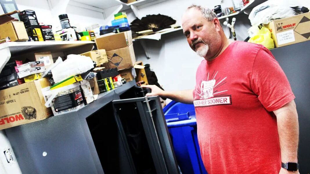 Russell Fincher in Front of Gun Safe