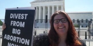 Lauren Handy, the director of activism with Progressive Anti-Abortion Uprising, protests outside the U.S. Supreme Court