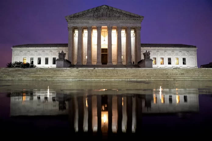 The Supreme Court is reflected in a puddle in Washington on April 5 The Supreme Court is reflected in a puddle in Washington on April 5