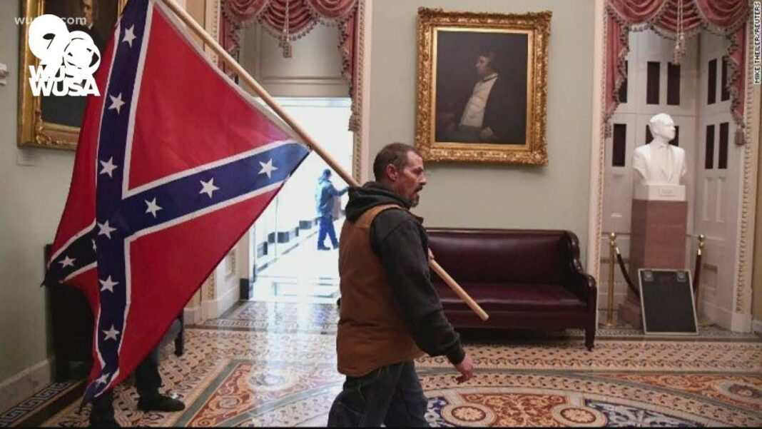 Man Who Carried Confederate Flag in Capitol riots waved preliminary hearings