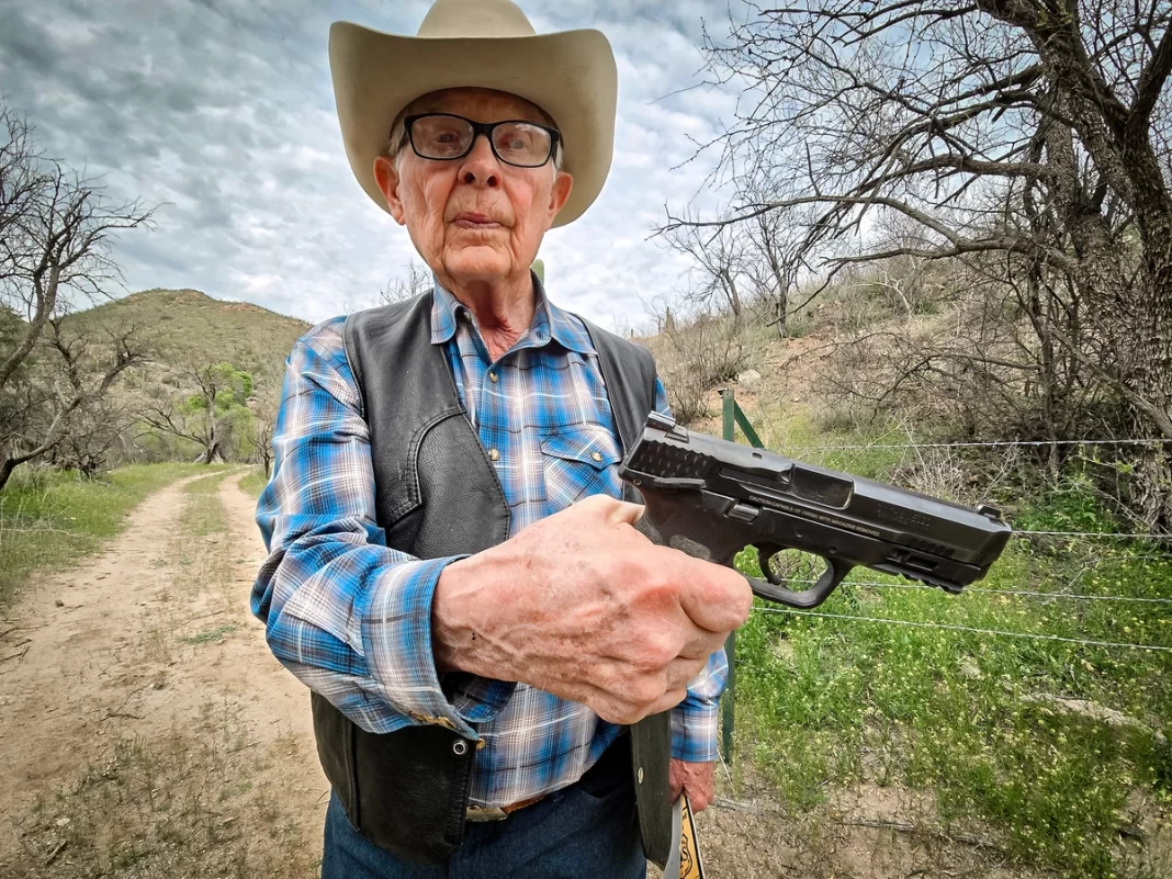 Cattle rancher Jim Chilton displays the 40-caliber handgun he carries when he goes out on his 50,000-acre ranch in Arivaca, Ariz., on March 22, 2024.