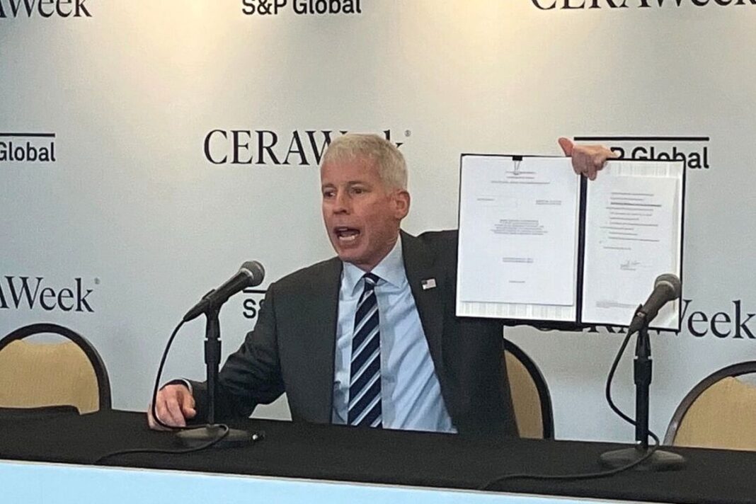 Energy Secretary Chris Wright displays the order he signed in March approving Delfin LNG LLC’s permit.