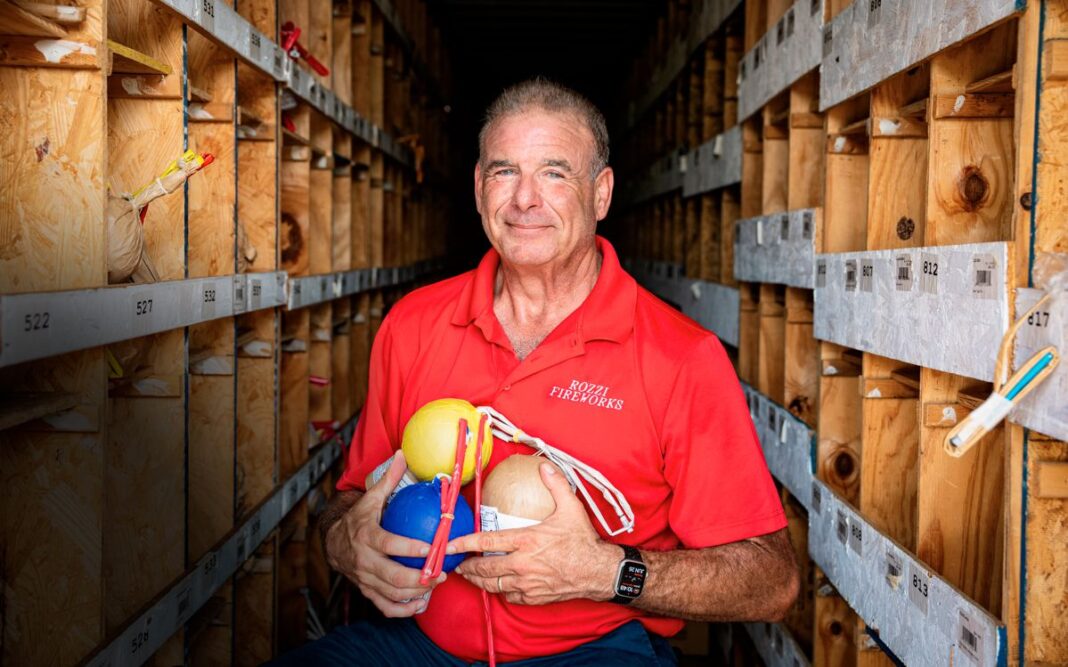 Joe Rozzi holds fireworks shells in a storage area at the company’s show-preparation site in Martinsville, Ohio, on June 26, 2025.