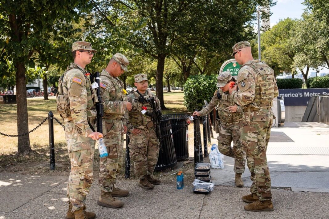 Armed National Guard members patrol the National Mall in Washington on Aug. 27, 2025.