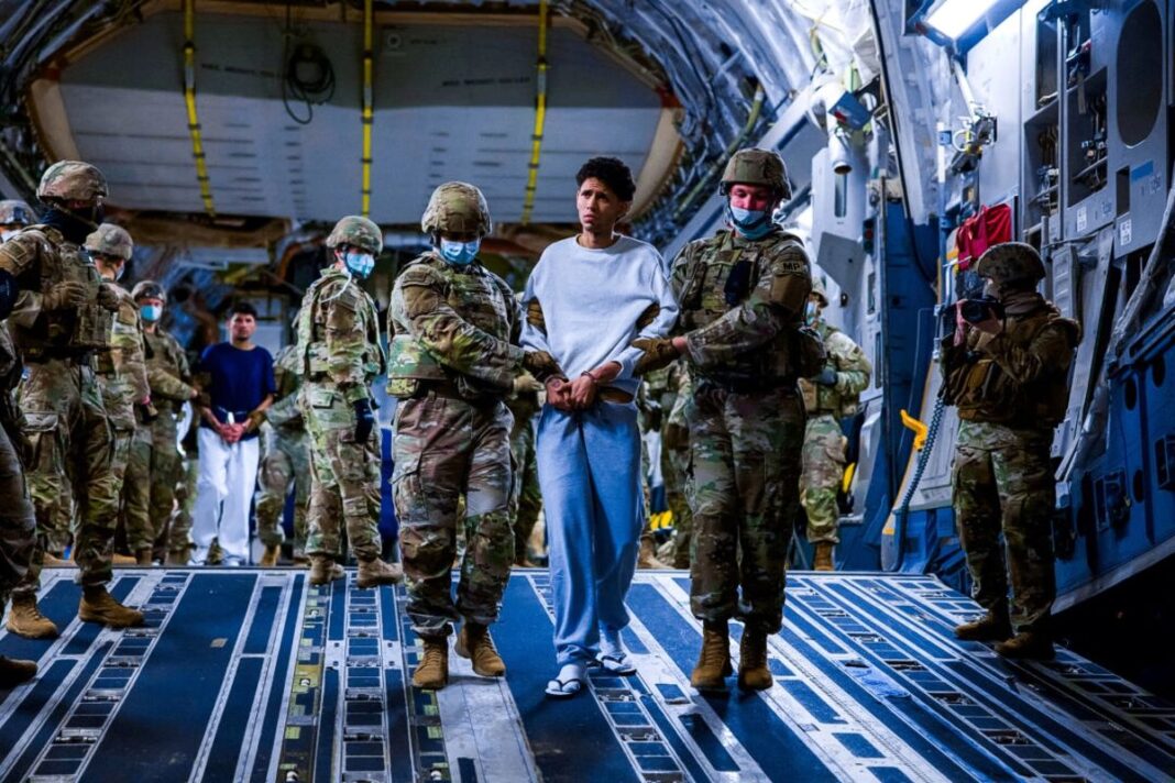 U.S. military escort alleged gang members deported by the U.S. government to CECOT prison.