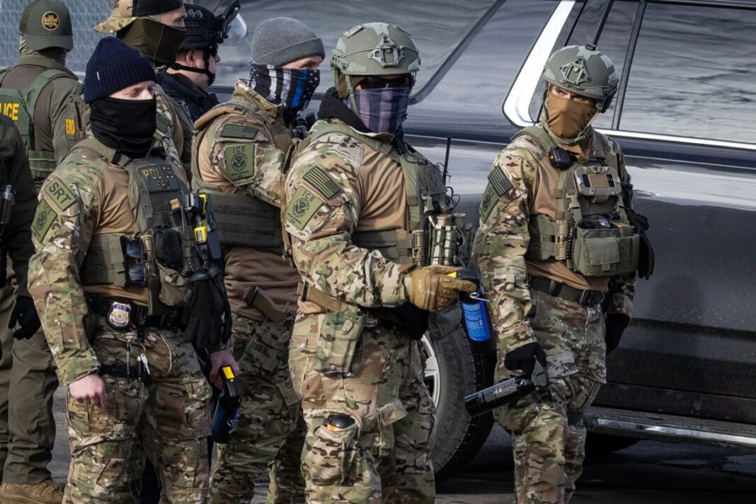 ICE agents in front of the Bishop Henry Whipple Federal Building in Minneapolis on Jan. 12, 2026