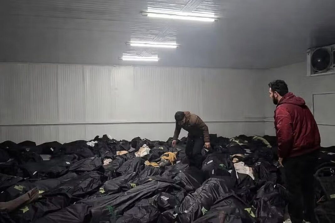 Men stand amid rows of corpses in a morgue in Tehran following mass killings of protestors by security forces in this undated image obtained by Iran International