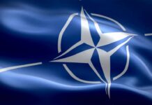 Key Takeaways From NATO Summit waving flag of NATO